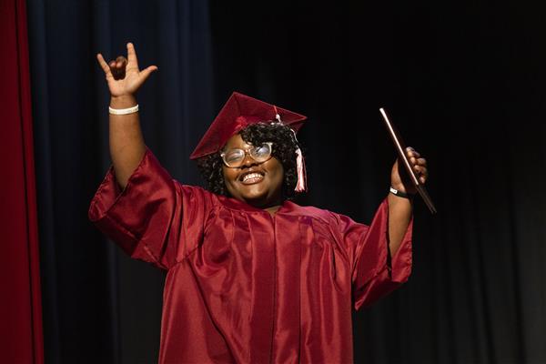 An ASD 2023 Graduate signs \